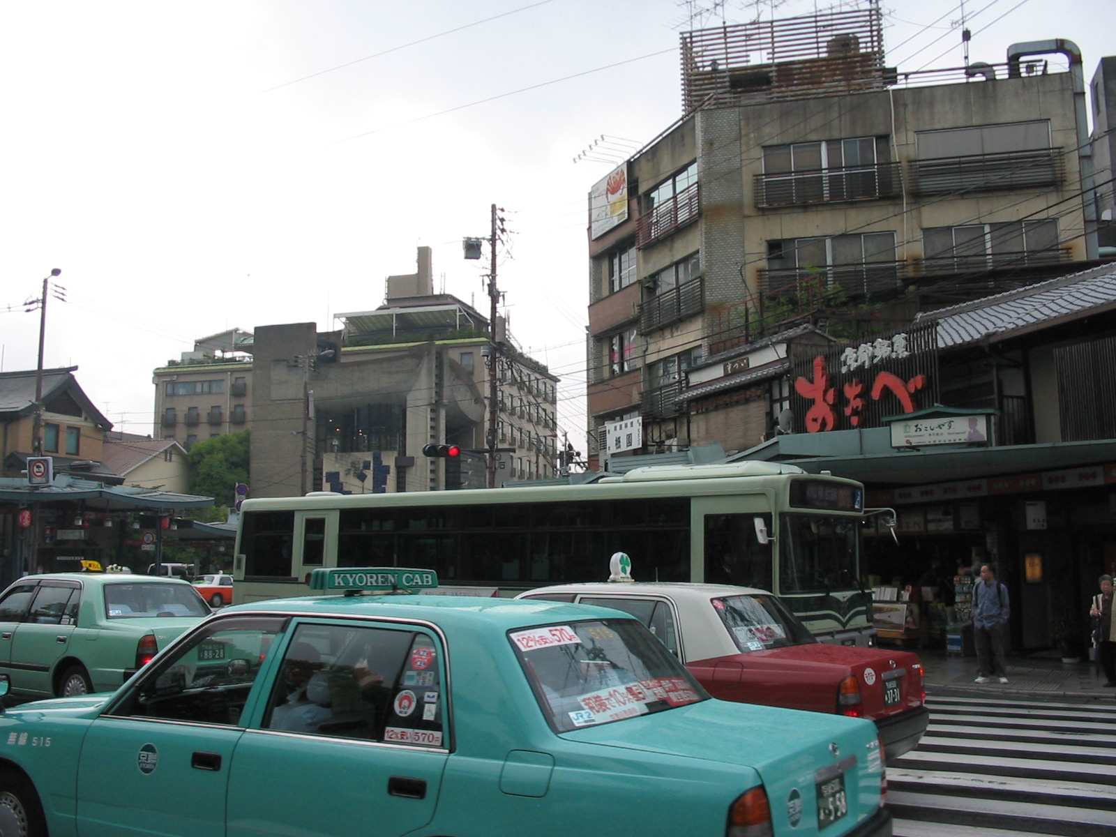 traffic in street in front of rundown short buildings