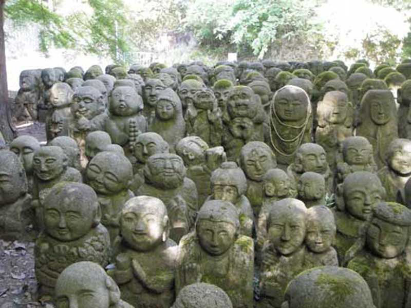 many small statues in a garden
