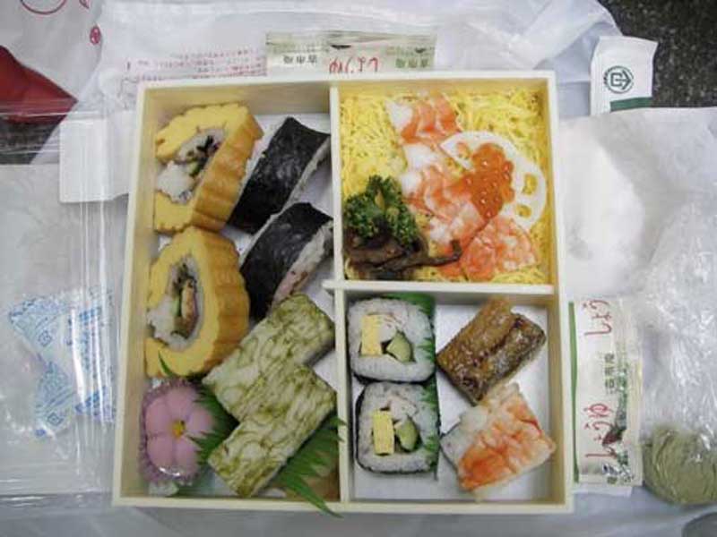 bento box with sushi and soy sauce container