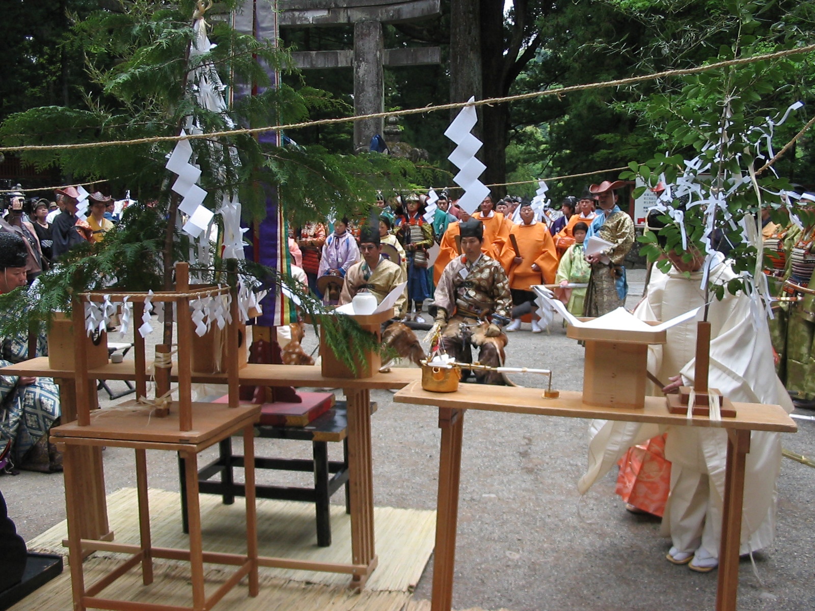 men in traditional garb sitting in front of a table