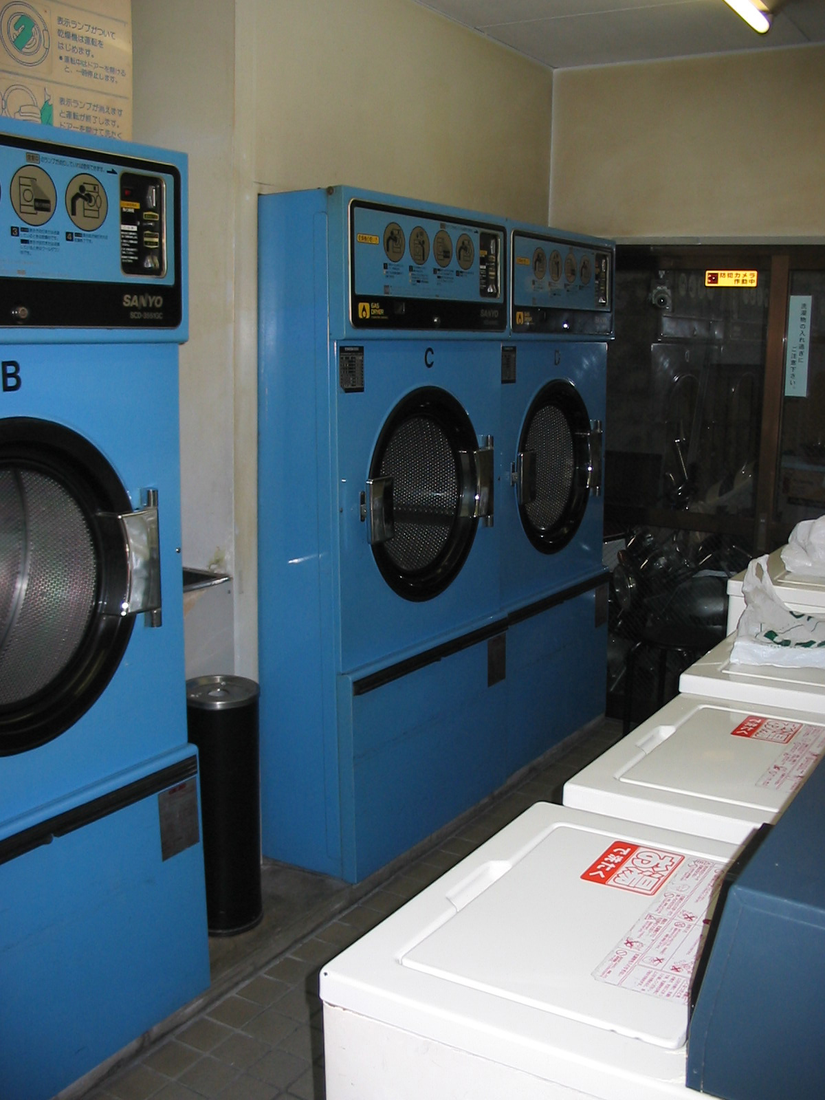 inside laundromat with blue narrow washing machines
