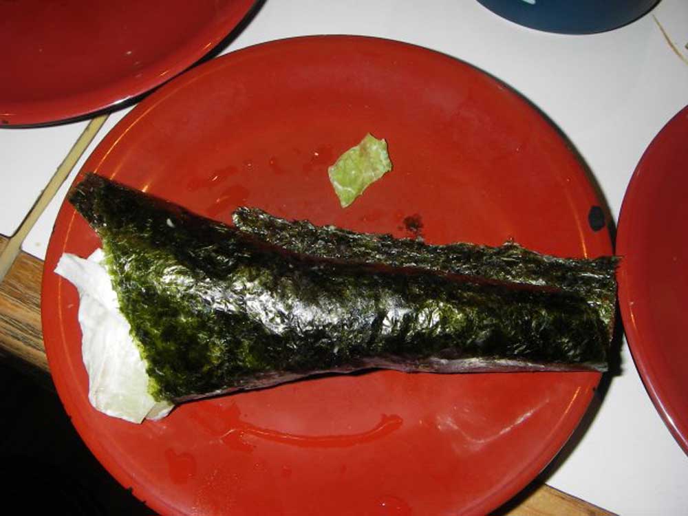large sushi roll with rice wrapped in seaweed
