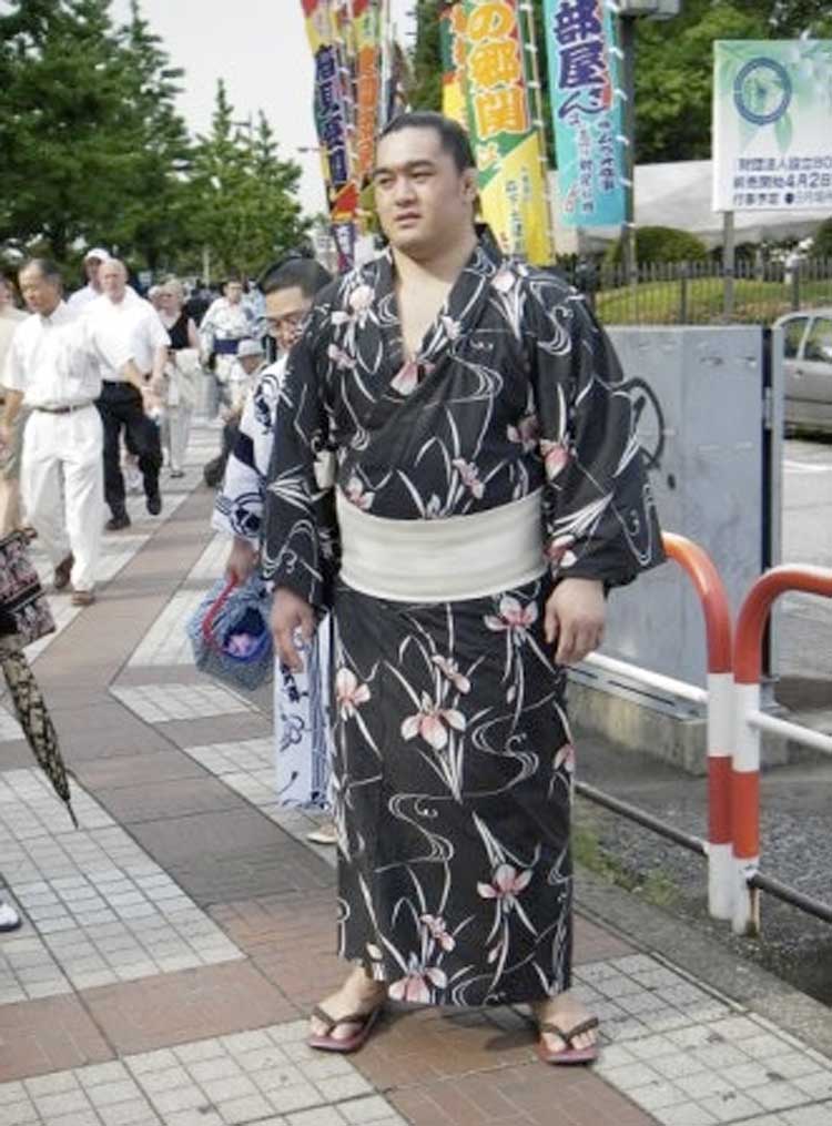 man in robe outside stadium